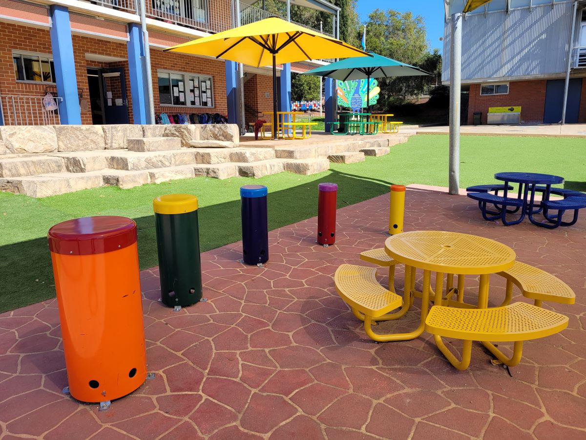 A colourful school yard with musical instruments and settings for students